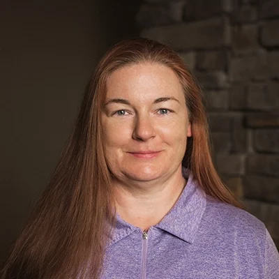 Massage Therapist Marie S. In Front Of Blurred Wall